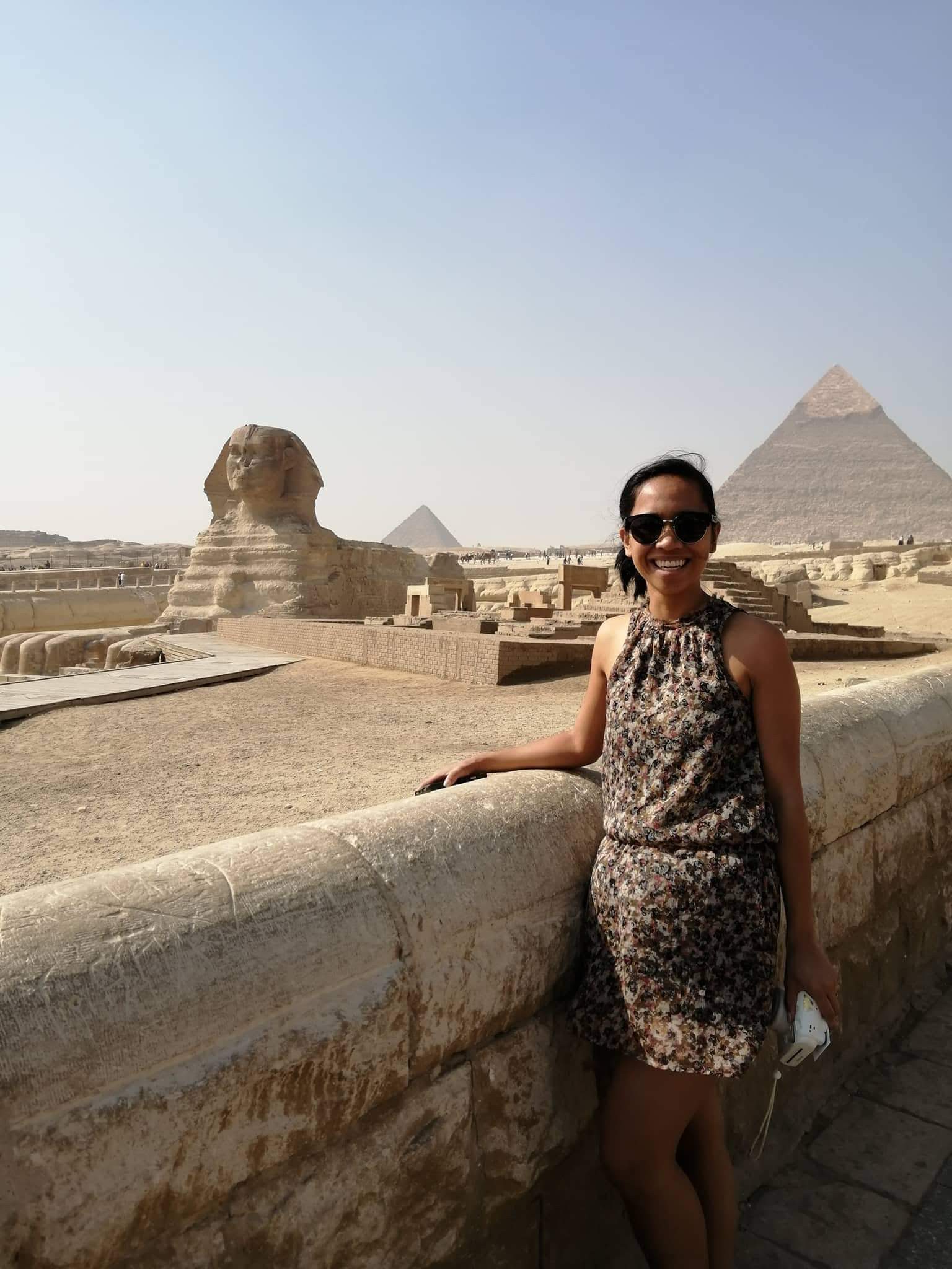 Jelly smiles wearing sunglasses, with the Sphinx and Pyramids of Giza in the background.
