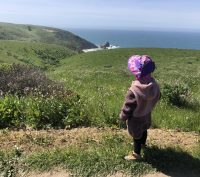 Child hiking along Tomales Point Trail in Point Reyes National Seashore, California