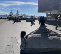 Two children standing on rocks in the middle of the Lonsdale District, Vancouver BC